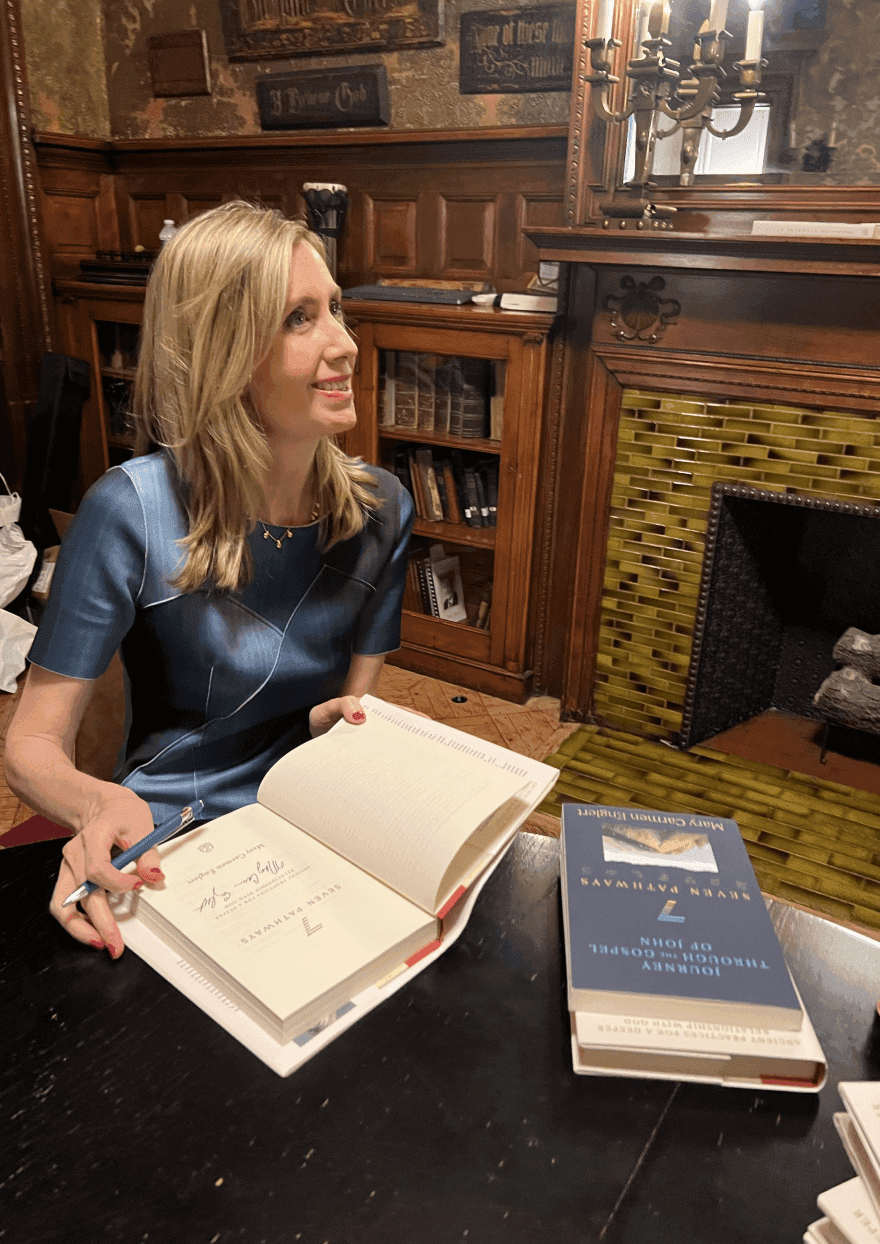 Mary Carmen signing a book